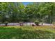 Private basketball court surrounded by trees and lush landscaping at 9831 Sedgefield Dr, Waxhaw, NC 28173