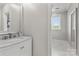 Bright bathroom with a marble countertop and a view into another room at 9831 Sedgefield Dr, Waxhaw, NC 28173