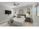 Serene bedroom with a ceiling fan, comfortable bed, and windows that offer natural light at 9831 Sedgefield Dr, Waxhaw, NC 28173