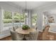 Dining room with round table, tufted chairs, and lots of natural light from the backyard pool view at 9831 Sedgefield Dr, Waxhaw, NC 28173