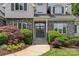 Elegant entrance featuring stone accents, a glass-paneled front door, and manicured landscaping at 9831 Sedgefield Dr, Waxhaw, NC 28173