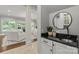 Entryway with elegant details, leading to a living room with white furniture and view of the backyard at 9831 Sedgefield Dr, Waxhaw, NC 28173