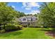 Beautiful home featuring mature trees and landscaped front yard on a sunny day at 9831 Sedgefield Dr, Waxhaw, NC 28173