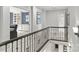 Second floor hallway with iron railing and views of the home's custom trim and built-ins at 9831 Sedgefield Dr, Waxhaw, NC 28173