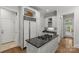 Elegant kitchen featuring an island cooktop, granite countertops and white cabinetry at 9831 Sedgefield Dr, Waxhaw, NC 28173