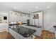 Elegant kitchen featuring granite countertops, white cabinetry, and a view into the living room at 9831 Sedgefield Dr, Waxhaw, NC 28173
