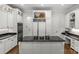 Spacious kitchen with an island cooktop, granite countertops and white cabinetry at 9831 Sedgefield Dr, Waxhaw, NC 28173