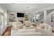 Bright and airy living room featuring built-in bookshelves, a fireplace, and staircase at 9831 Sedgefield Dr, Waxhaw, NC 28173