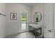 Stylish powder room with tiled floors, modern sink, and outdoor access to the pool at 9831 Sedgefield Dr, Waxhaw, NC 28173