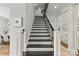 Elegant staircase with wrought iron railing and hardwood treads at 9831 Sedgefield Dr, Waxhaw, NC 28173