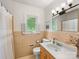 Neutral bathroom with a window view, classic fixtures, and ample natural light at 1031 Eldorado Ave, Charlotte, NC 28262
