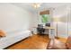 Well-lit bedroom features hardwood floors, a ceiling fan, and a dedicated office space at 1031 Eldorado Ave, Charlotte, NC 28262