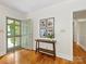 Inviting entryway with hardwood floors, a stylish console table, and a view to the living area at 1031 Eldorado Ave, Charlotte, NC 28262