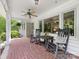 Cozy front porch featuring brick flooring, rocking chairs, and a ceiling fan at 1031 Eldorado Ave, Charlotte, NC 28262
