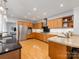 Well-lit kitchen with wood cabinets, stainless steel appliances, and hardwood floors at 1031 Eldorado Ave, Charlotte, NC 28262