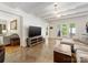 Comfortable living room featuring a plush couch, large TV, and access to the backyard at 1031 Eldorado Ave, Charlotte, NC 28262