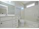 Clean bathroom featuring a shower-tub combo, toilet, and white vanity for a functional space at 105 Woodsong Ln, Mooresville, NC 28117