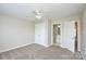 Bedroom features carpet and ceiling fan, closet and door to bathroom at 105 Woodsong Ln, Mooresville, NC 28117