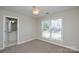 Bright bedroom featuring a large window and neutral decor, creating a calm and inviting space at 105 Woodsong Ln, Mooresville, NC 28117