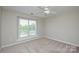 Bedroom with natural light provided from a large window with blinds and ceiling fan at 105 Woodsong Ln, Mooresville, NC 28117