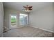 Bright bedroom with plush carpet, ceiling fan, and access to balcony at 105 Woodsong Ln, Mooresville, NC 28117
