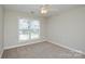 Bedroom with natural light provided from a large window with blinds and ceiling fan at 105 Woodsong Ln, Mooresville, NC 28117