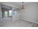 Neutral dining room with plush carpeting, complemented by natural light at 105 Woodsong Ln, Mooresville, NC 28117