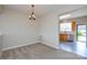 Neutral dining room with plush carpeting and access to kitchen area at 105 Woodsong Ln, Mooresville, NC 28117