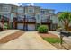 Exterior of townhouses with attached garages and decks, showing modern living in a community setting at 105 Woodsong Ln, Mooresville, NC 28117