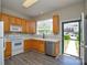Bright kitchen featuring updated appliances, laminate flooring, and a view of the outdoors at 105 Woodsong Ln, Mooresville, NC 28117