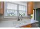 Well-lit kitchen sink area with ample window views of the neighborhood at 105 Woodsong Ln, Mooresville, NC 28117
