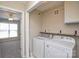 Laundry room with appliances and storage; door into bedroom with ceiling fan at 105 Woodsong Ln, Mooresville, NC 28117