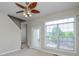 Bright living room features a modern ceiling fan, natural light from a large window, and door to outside at 105 Woodsong Ln, Mooresville, NC 28117