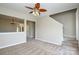 Spacious living room with neutral carpet, paint, and ceiling fan plus view into front hall at 105 Woodsong Ln, Mooresville, NC 28117