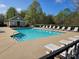 Community pool featuring lounge chairs, a pool house, and clear blue water for residents' enjoyment at 105 Woodsong Ln, Mooresville, NC 28117