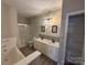 Modern bathroom with double vanity, soaking tub, and walk-in shower at 10673 Hill Point Ct, Charlotte, NC 28262