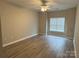 Neutral bedroom with wood floors, lots of natural light and a ceiling fan at 10673 Hill Point Ct, Charlotte, NC 28262