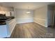 Open-concept dining area with wood floors and modern lighting at 10673 Hill Point Ct, Charlotte, NC 28262