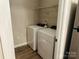 Convenient laundry room featuring a full-size washer and dryer and practical shelving at 10673 Hill Point Ct, Charlotte, NC 28262