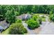 Aerial view of home with lush landscaping, long driveway, and screened in porch overlooking verdant green surroundings at 109 Gatwick Ct, Statesville, NC 28677