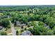 Aerial view of the home in a leafy neighborhood with lush lawns and mature trees at 109 Gatwick Ct, Statesville, NC 28677
