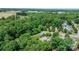 An aerial view of the house showing it is nestled into a grove of mature trees at 109 Gatwick Ct, Statesville, NC 28677