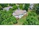 Aerial view of the rear of the house showing deck, back yard and mature trees and plantings at 109 Gatwick Ct, Statesville, NC 28677