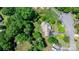 Aerial view of a property featuring a well-maintained house, driveway, and tree coverage at 109 Gatwick Ct, Statesville, NC 28677