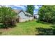 Spacious backyard featuring a well-maintained lawn, landscaping, and mature trees at 109 Gatwick Ct, Statesville, NC 28677