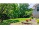 Lush backyard with mature trees, landscaping, and a serene view of the surrounding nature at 109 Gatwick Ct, Statesville, NC 28677