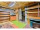 Partially finished basement area with shelving, storage, painted floors, and access to other areas at 109 Gatwick Ct, Statesville, NC 28677