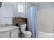 Bright bathroom featuring a vanity with marble countertop, a sliding barn door cabinet, and a bathtub with shower at 109 Gatwick Ct, Statesville, NC 28677