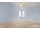Neutral bedroom featuring light blue walls, plush carpeting, and window at 109 Gatwick Ct, Statesville, NC 28677