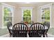 Dining area with a round wood table and six chairs near bright windows at 109 Gatwick Ct, Statesville, NC 28677